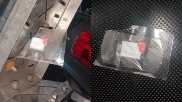 摩托车疑被藏毒 越堤族及时发现两粒毒丸急报警