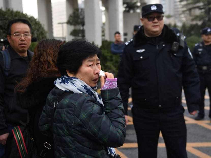 Relatives of passengers of missing Malaysia Airlines flight MH370 wait outside the Foreign Ministry in Beijing on March 8, 2019. 
