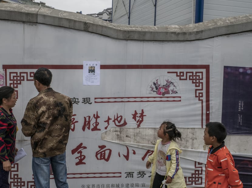 Liao Mandong and her husband, Tang Chunwu, in Zhangjiajie, China, looking for their son, Tang Gongwei, a pharmacist who disappeared after learning he had stomach cancer. Millions in China cannot afford treatments for serious illnesses, and insurance coverage of major illnesses like cancer is low.