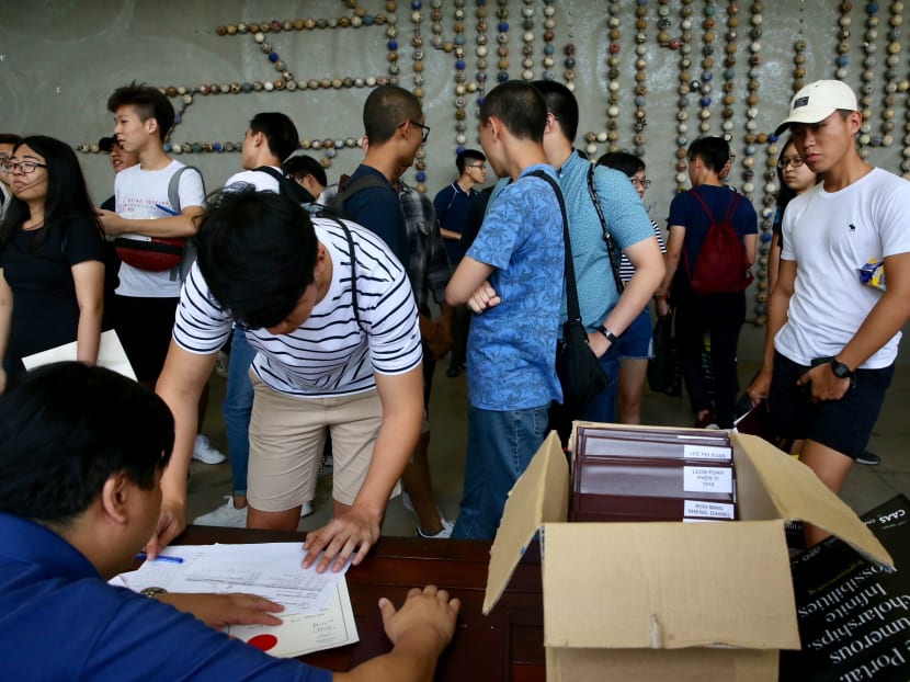 Former students collecting their GCE A-Level results at Nanyang Junior College in 2018. This year's results will be released on Feb 22 (Friday) and school candidates will receive their results from their respective schools from 2.30pm onwards.