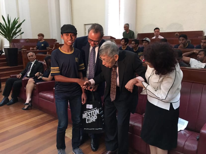 Mr Chiam See Tong (second from right) presenting a new pair of football boots to a beneficary of his new sports foundation, which aims to help children and teens from under-privileged backrounds to fulfill their sporting dreams. Next to Mr Chiam are Mr Ang Peng Siong (left), chairman of the foundation's board of directors, and Mrs Lina Chiam (right). Photo: Noah Tan