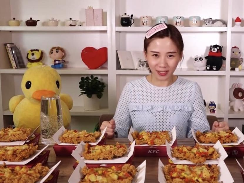 Mizijun, a female vlogger previously known as Big Stomach Mizijun and one of the pioneers of mukbang, or binge-eating, in China, about to attempt to eat a large quantity of “Chizza” chicken pizza from KFC in a video capture from her YouTube channel. Mizijun, a female vlogger previously known as Big Stomach Mizijun and one of the pioneers of mukbang, or binge-eating, in China, about to attempt to eat a large quantity of “Chizza” chicken pizza from KFC in a video capture from her YouTube channel.