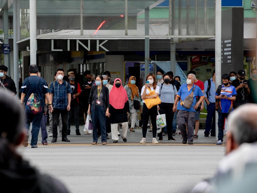 Pedestrians at a traffic light junction near JCube shopping mall in Jurong East on May 17, 2021.