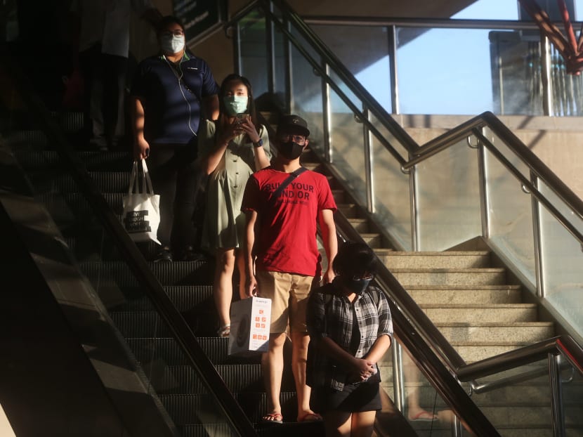 People wearing face masks on an escalator on April 15, 2020. The Government's advisory switched from discouraging people who are well from wearing a mask to making it mandatory to put on a face mask when heading outdoors. People wearing face masks on an escalator on April 15, 2020. The Government's advisory switched from discouraging people who are well from wearing a mask to making it mandatory to put on a face mask when heading outdoors.