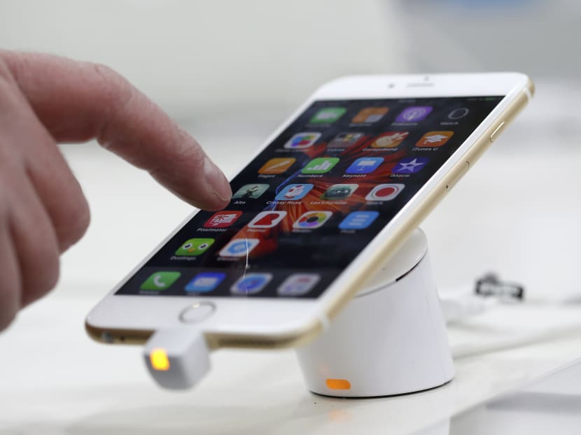 A man tests a mobile phone, an iPhone 6 by Apple in a shop in Munich, Germany, January 27, 2016. Photo: Reuters A man tests a mobile phone, an iPhone 6 by Apple in a shop in Munich, Germany, January 27, 2016. Photo: Reuters