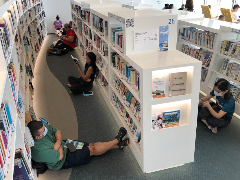 People hanging out in an air-conditioned library at Vivocity on May 14, 2023.