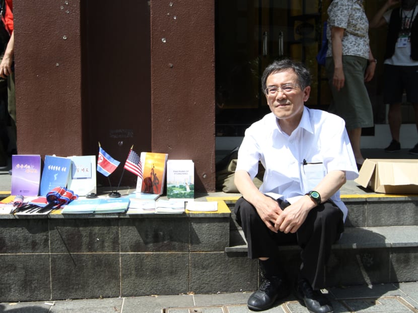 Mr Miyagawa Jun showcasing the North Korean products that he has for sale outside the St Regis Hotel, where North Korean leader Kim Jong-un is staying at, ahead of a historic summit between Mr Kim, and US President Donald Trump.