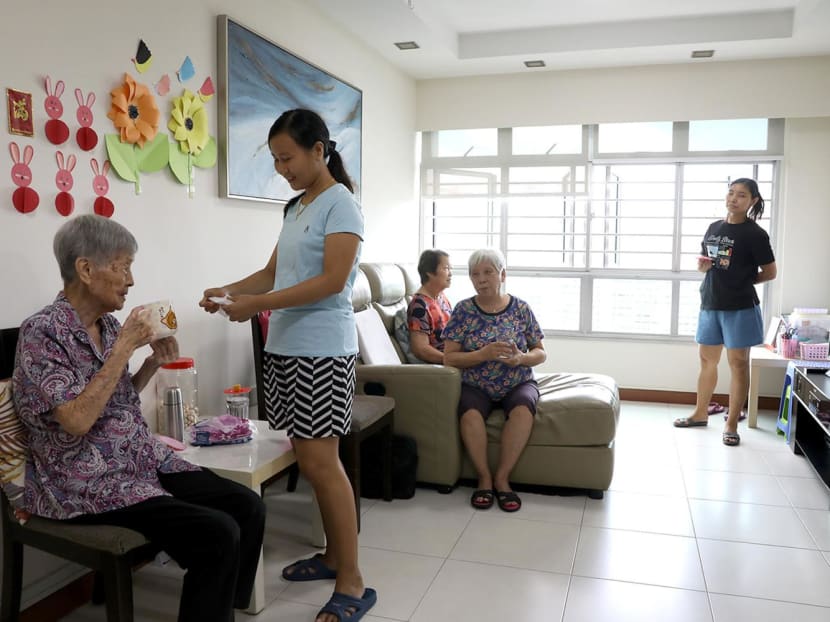 Elderly residents and two domestic workers (standing) staying in an HDB flat managed by Red Crowns Senior Living. Elderly residents and two domestic workers (standing) staying in an HDB flat managed by Red Crowns Senior Living.
