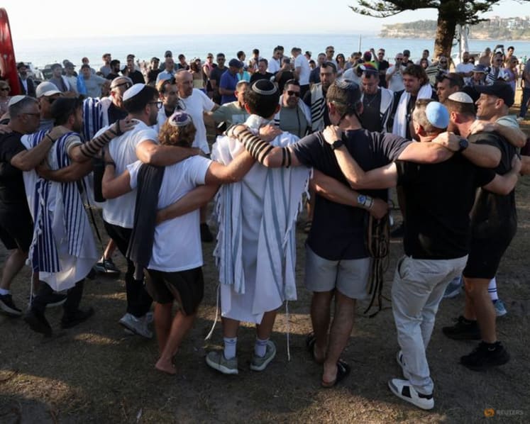 Australian Jews hold prayers, hundreds of surfers paddle out at Bondi to honour shooting victims