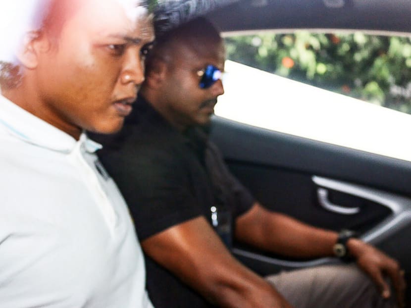 The suspect (left) in the Khoo Teck Puat Hospital shooting seen here leaving the State Courts in a police vehicle. Photo: Calvin Oh