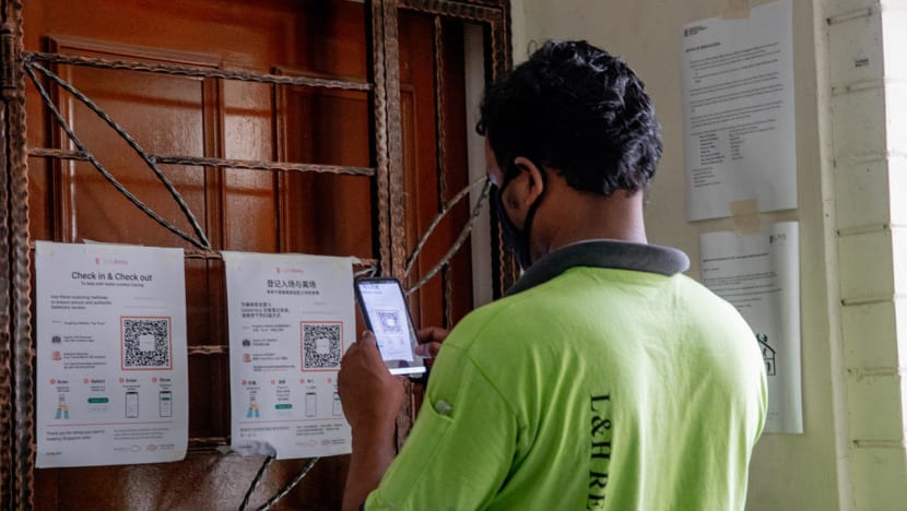 Migrant workers learn to use apps for contact tracing, health reporting before they can resume work
