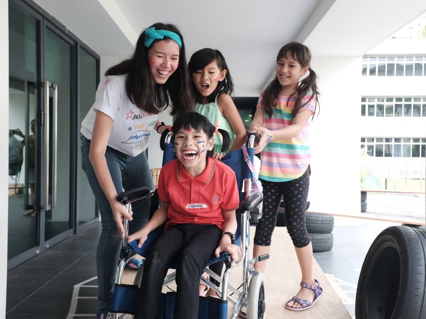 When her new-found friend Qistina Cheong, 9, who has cerebral palsy (centre), wanted to play on a wheelchair-friendly see-saw, 8-year-old Joy Sexton (rightmost) raced to help her bubbly friend with pushing her wheelchair. The two had become fast friends after Superhero We three-day inclusive arts camp, for 31 children with and without disabilities which ended on Wednesday (Mar 14). Photo: Toh Ee Ming/TODAY