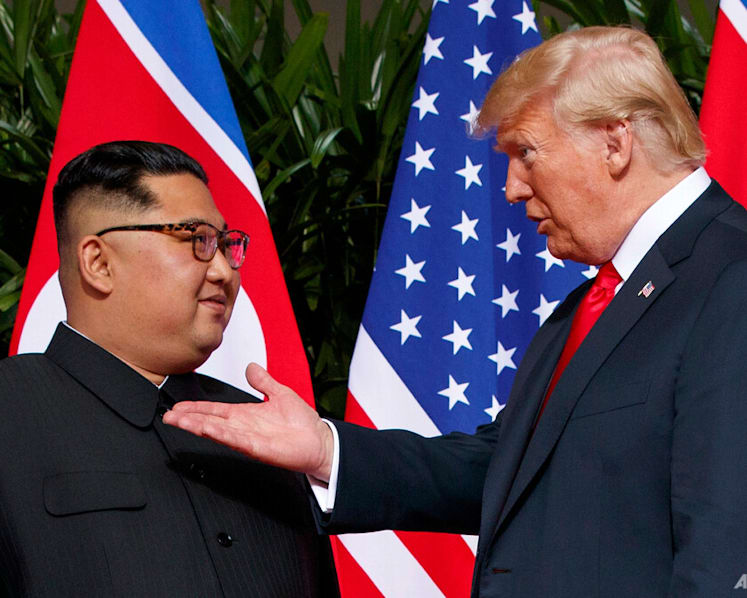 Trump hints at Kim contacts after scaling back Seoul drills