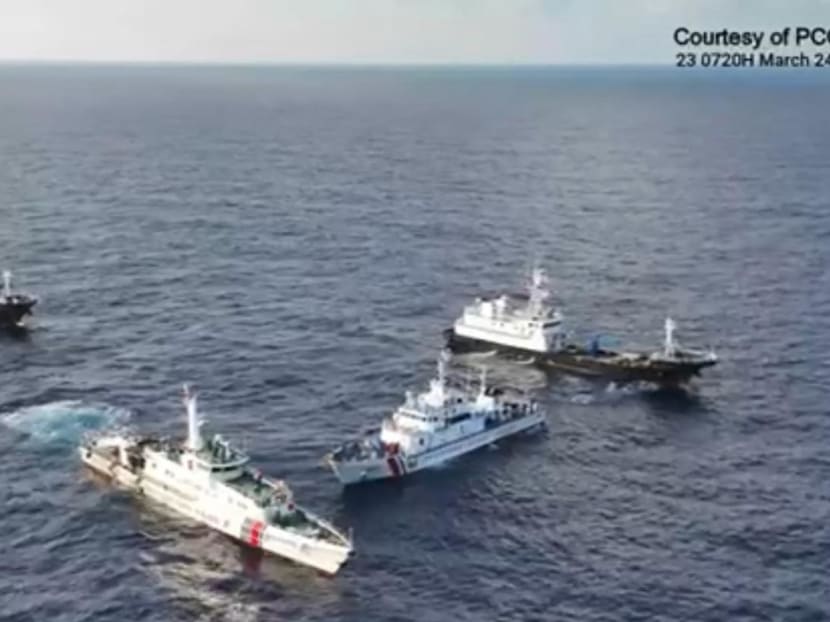 A China Coast Guard ship (second from left) and vessels identified by the Philippine Coast Guard as “Chinese Maritime Militia” (left and right) surrounding the Philippine Coast Guard ship BRP Cabra (second from right) during its supply mission near Second Thomas Shoal in waters of the disputed South China Sea on March 23, 2024. 