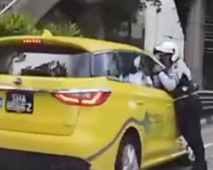 Taxi driver, 69, arrested for closing window on traffic cop's arm, dragging him along the road for several metres