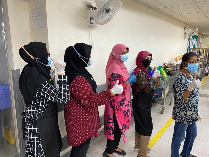 Ms Neo Su Yin’s colleagues wearing mask straps that she knitted for them.
