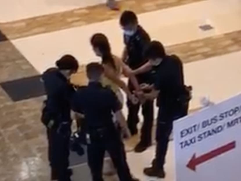 A screengrab of a video posted on social media showing police officers placing handcuffs on a 35-year-old woman before she is led away. A screengrab of a video posted on social media showing police officers placing handcuffs on a 35-year-old woman before she is led away.