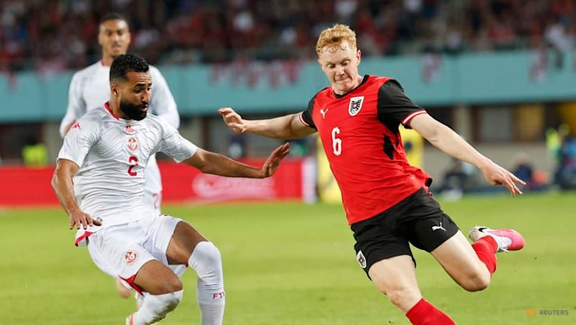 Austria fight back from early red card to beat Tunisia