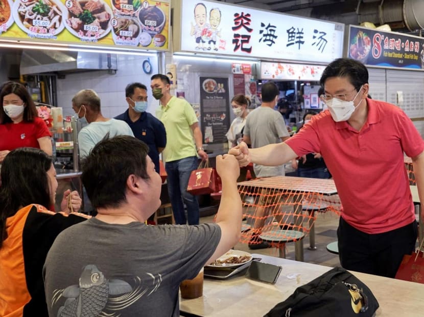 Mr Lawrence Wong greeting a resident in January 2022. Mr Lawrence Wong greeting a resident in January 2022.