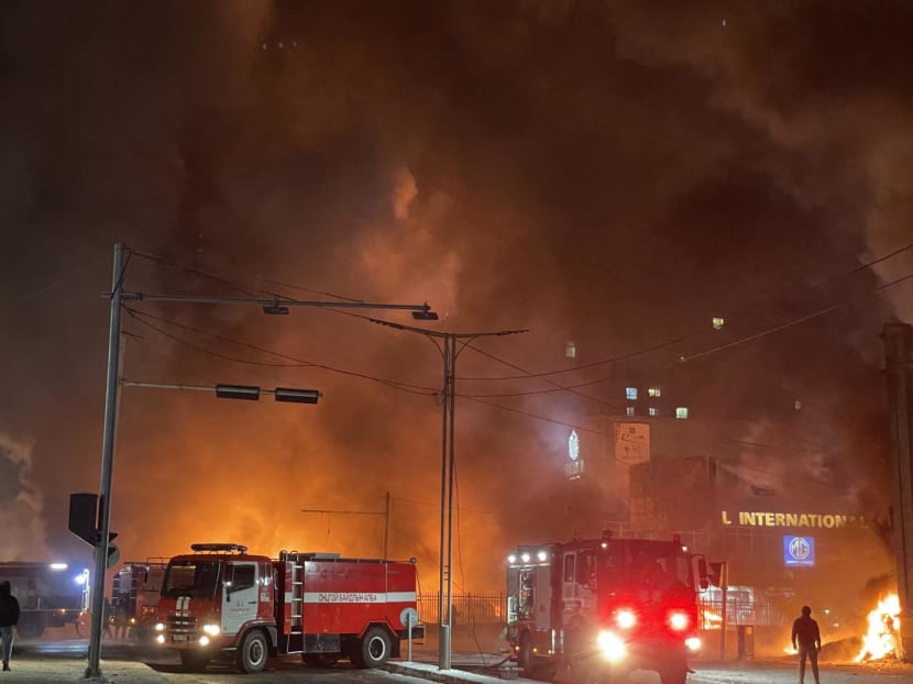 Firefighters work at the scene of an explosion from a vehicle crash in Ulaanbaatar, the capital of Mongolia on Jan 24, 2024.