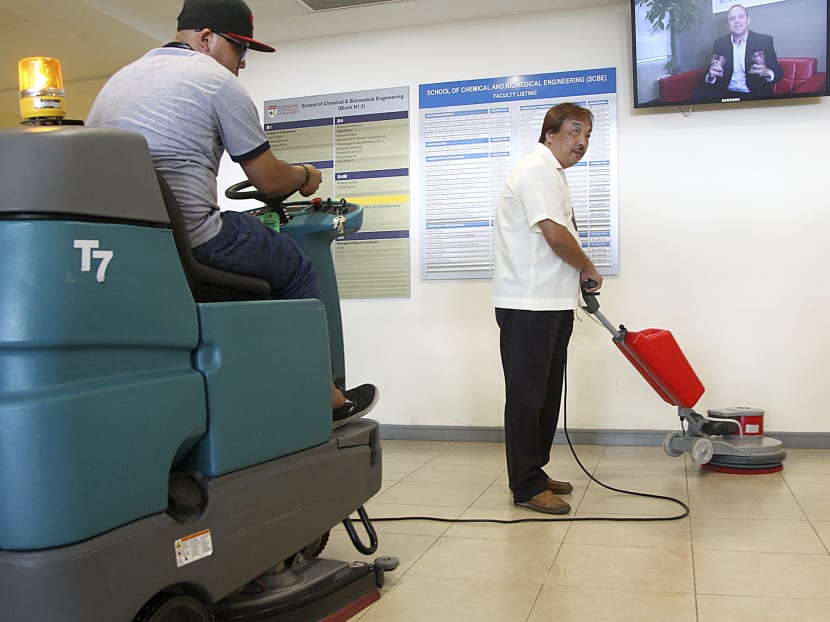 A pair of cleaners using automated help in their tasks at an office building. Photo: Don Wong/TODAY
