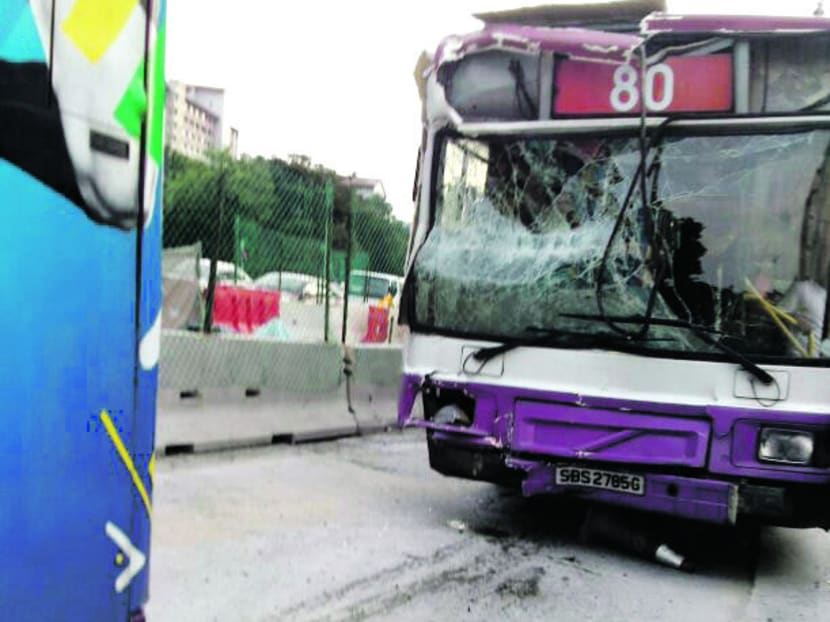 The two SBS Transit buses, one single-deck and the other double-deck, collided at a slip road leading into Sims Avenue. 
PHOTO: DORA CHIU