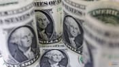 US dollar rises, but on track for weekly drop ahead of Fed, BOJ