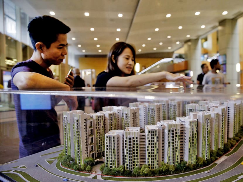 People looking at models of BTO flats at HDB Hub. TODAY file photo