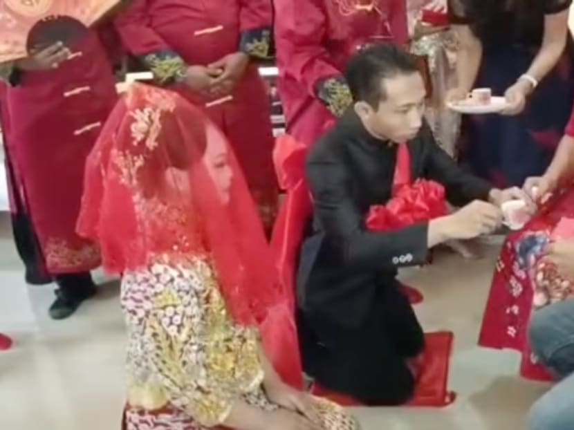 A Malay groom pictured offering tea to his new in-laws in a traditional Chinese wedding tea ceremony. A Malay groom pictured offering tea to his new in-laws in a traditional Chinese wedding tea ceremony.