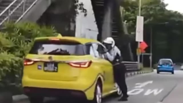 德士司机用车窗夹住交警手臂致骨折 判监七日禁驾八个月