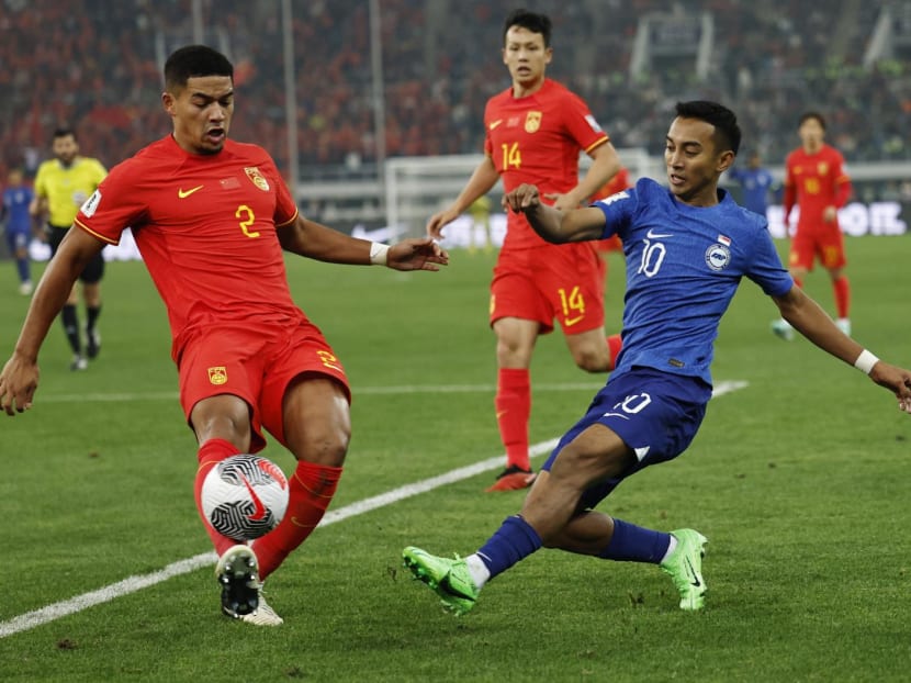 Singapore's Faris Ramli (in blue) in action with China's Jiang Guangtai during the 2026 FIFA World Cup qualifier at the Tianjin Olympic Center, Tianjin, China on March 26, 2024.