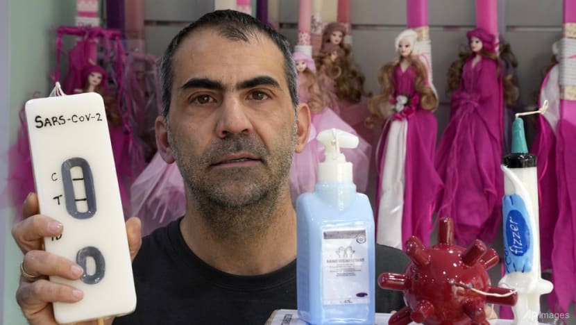 COVID-themed candles on sale in Greece for Orthodox Easter
