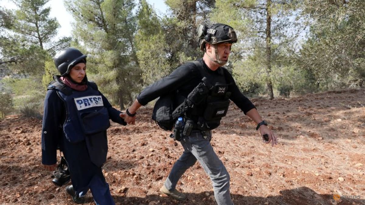 Israeli settlers attack Palestinians, journalists at West Bank olive harvest, witnesses say
