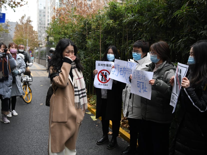 Ms Zhou Xiaoxuan (centre), a feminist figure who rose to prominence during China’s #MeToo movement two years ago, stands amongst her supporters as she arrives at the Haidian District People’s Court in Beijing on Dec 2, 2020, in a sexual harassment case against one of China's best-known television hosts.