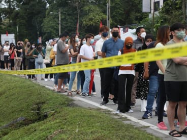 People waiting in line outside a polling centre in Tambun to cast their votes in Malaysia’s 15th general election on Nov 19, 2022.