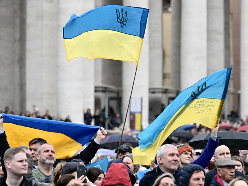 People wave Ukrainian flags at St Peter's square as Pope Francis addresses the crowd during his Sunday Angelus prayer on March 10, 2024 at the Vatican. People wave Ukrainian flags at St Peter's square as Pope Francis addresses the crowd during his Sunday Angelus prayer on March 10, 2024 at the Vatican.