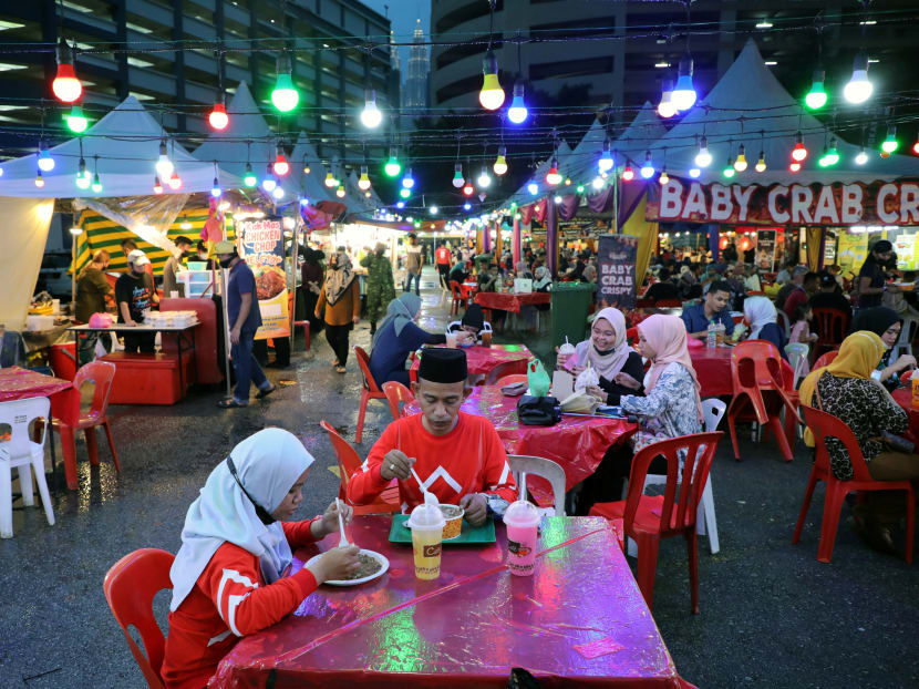 Muslims break their fast at the end of the day during the holy month of Ramadan at a bazaar, amid the Covid-19 outbreak, in Kuala Lumpur, Malaysia on May 4, 2021. Muslims break their fast at the end of the day during the holy month of Ramadan at a bazaar, amid the Covid-19 outbreak, in Kuala Lumpur, Malaysia on May 4, 2021.