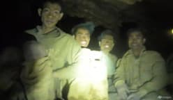 Rescuers evacuate the first of 5 villagers found trapped in a cave in Laos; 2 still missing