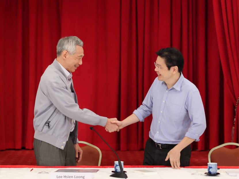 Prime Minister Lee Hsien Loong shaking the hand of Deputy Prime Minister Lawrence Wong at a press conference on April 16, 2022. Prime Minister Lee Hsien Loong shaking the hand of Deputy Prime Minister Lawrence Wong at a press conference on April 16, 2022.