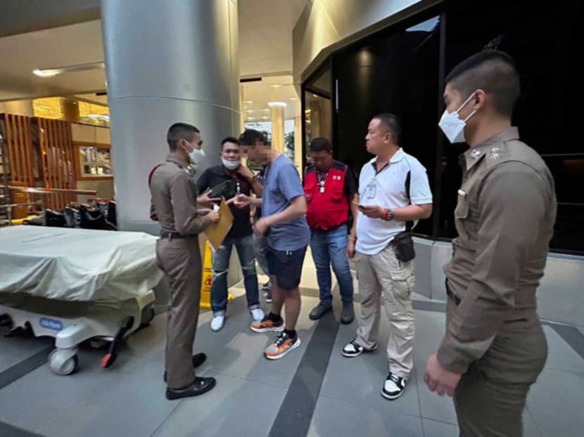 Thai police with the Qatari man (in blue T-shirt) suspected of sexually assaulting an 18-year-old male worker from a fast-food establishment in Bangkok.