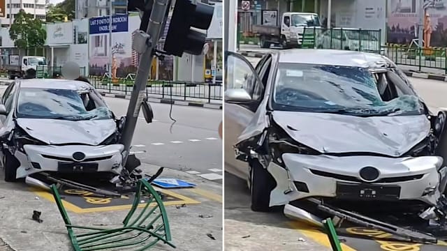 轿车冲破围栏撞歪红绿灯 33岁司机助查