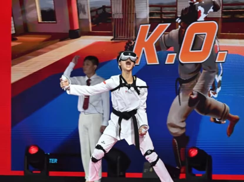 Virtual Taekwondo player Nigel Tan from Singapore celebrates after winning the Olympic Esports Series 2023 taekwondo event at the Suntec Singapore Convention & Exhibition Centre on June 25, 2023.
