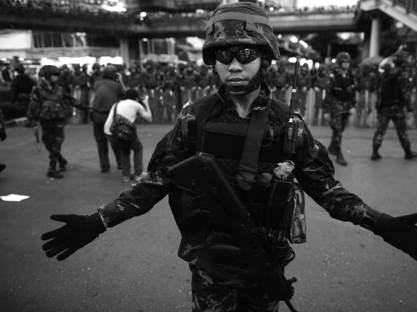 The coup is necessary to avoid the escalation of the political conflict to the point of bloody confrontations, but what is more important is that all the economic policies remain about the same, says Mr Boontuck Wungcharoen. PHOTO: AP