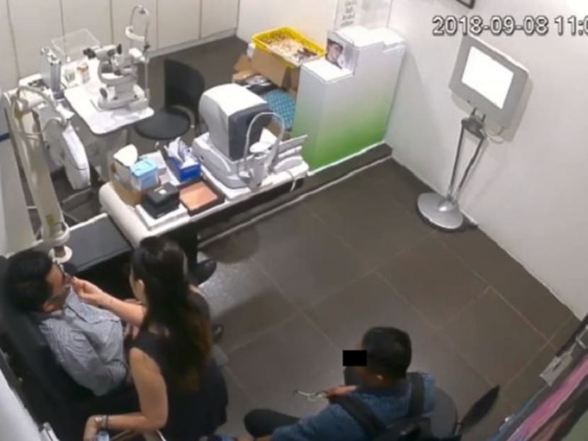 A screengrab showing the aide to a Malaysian deputy minister filming up the skirt of a woman at an optical shop in Kuala Lumpur.