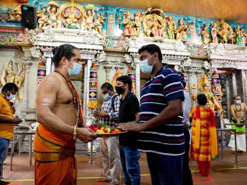 Migrant workers praying at the Sri Veeramakaliamman Temple in Little India on Sept 15, 2021.