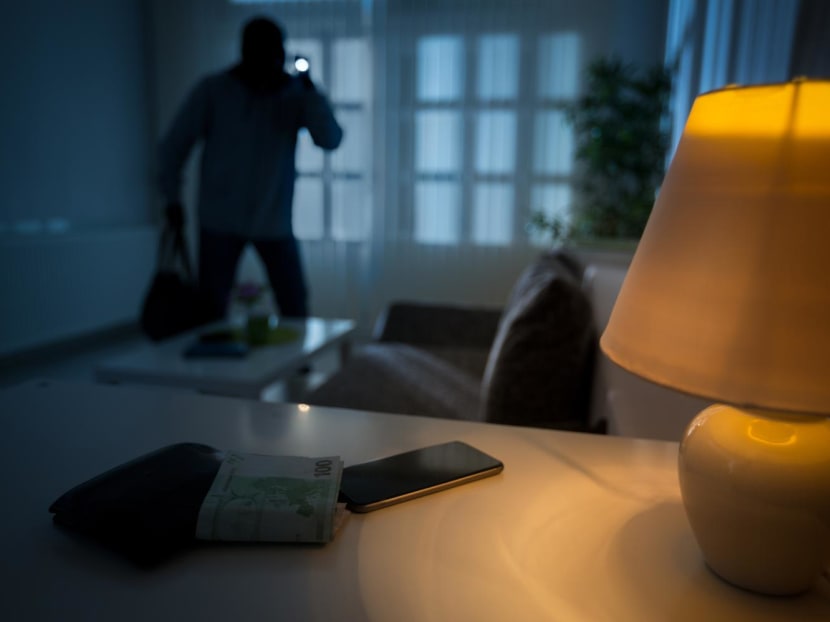 The housebreaker was rummaging through items to steal in the living room when a woman woke up and asked him who he was. The housebreaker was rummaging through items to steal in the living room when a woman woke up and asked him who he was.