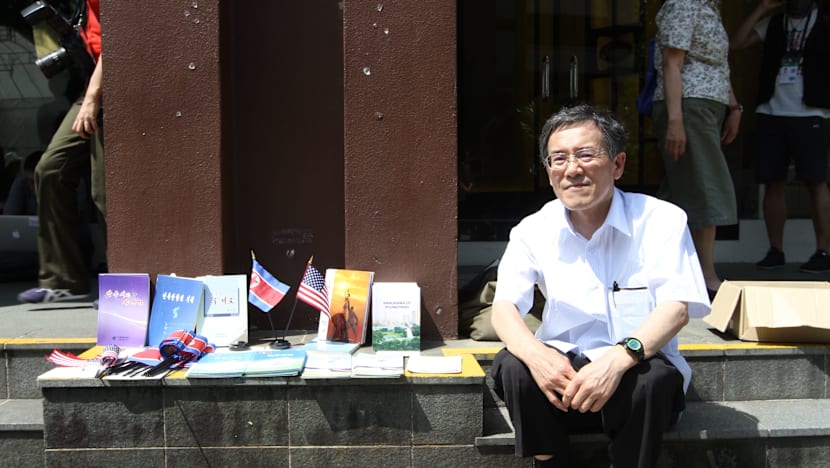 No sign of Kim at St Regis, while a Japanese tourist sold North Korean souvenirs outside