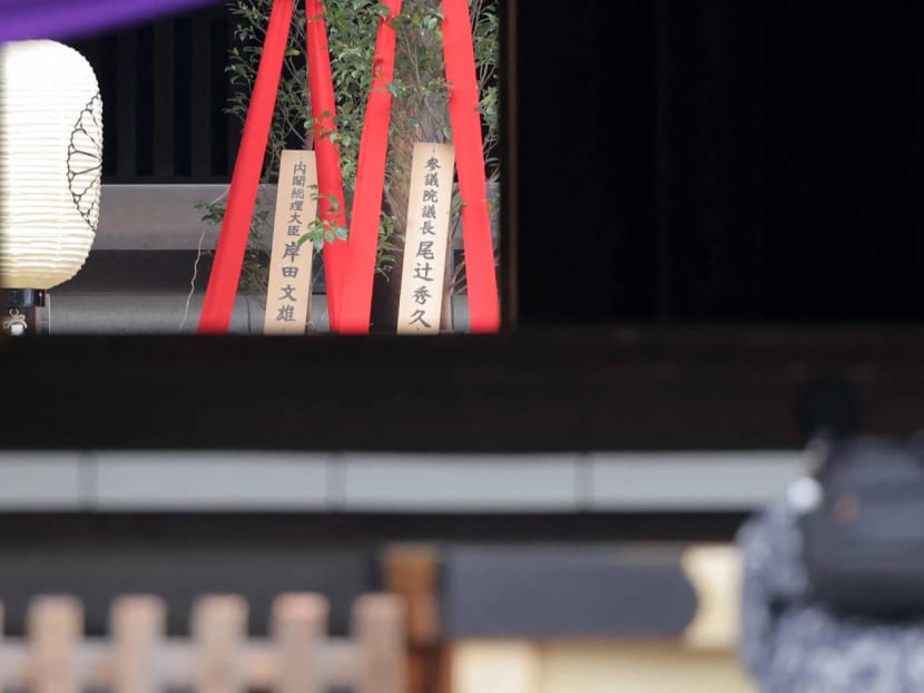 A wooden plaque showing the name of Japan's Prime Minister Fumio Kishida is seen with a "masakaki" tree (L) that he sent as an offering to the Yasukuni Shrine on the spring festival in Tokyo on April 21, 2024.