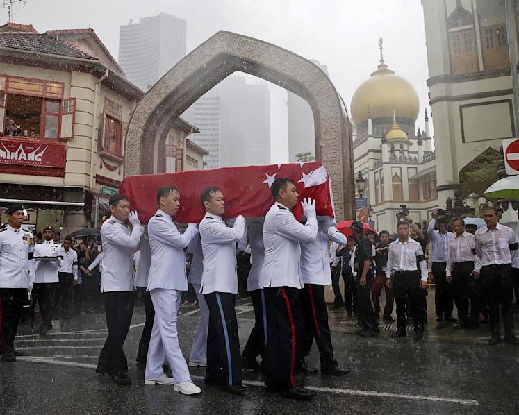 Crowds brave torrential downpour as Othman Wok is laid to rest
