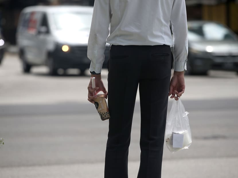 A worker in Singapore's Central Business District carrying packed food during lunch hour on May 20, 2021.